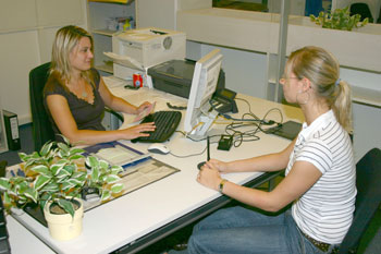 Das Bild zeigt eine Mitarbeiterin des Bürgerservice bei der Passausgabe 